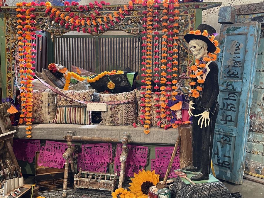 A large pink altar with skeletons and marigold created by artist Jessica Lagunas for Dia de Los Muertos