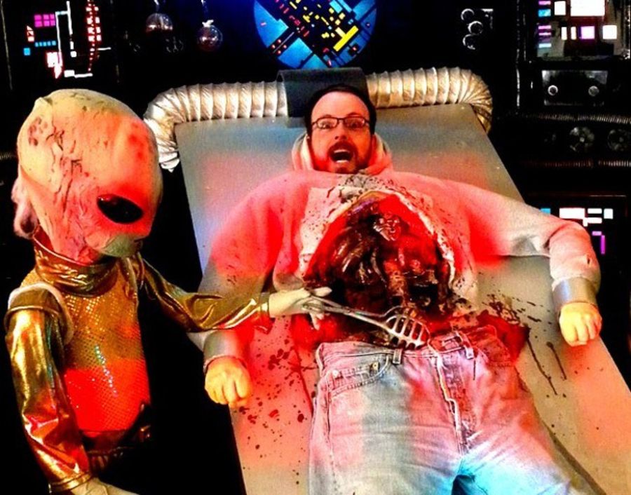 A man posing in a photo display appearing to discected from an alien at the Freakybuttrue Peculiarium