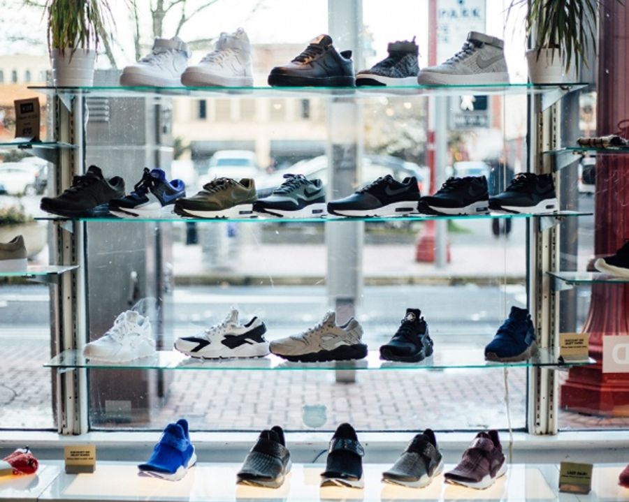 four rows of shoes displayed in a retail shop window