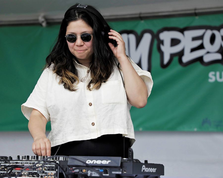 a DJ adjusts a knob on a mixer