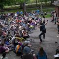 a person on a stage performs in front of a crowd with bikes