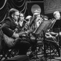 Black and White image of jazz ensemble on stage. 