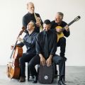Quarteto Nuevo playing their instruments and smiling.
