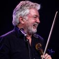 man smiling with a violin