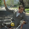 Pee Wee Herman riding a bike