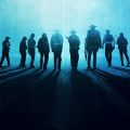silhouettes of a group of cowboys walking away 