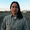 a woman stands in a field