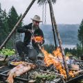 a person cooking over an open flame