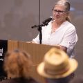 Woman stands at lectern