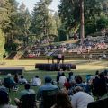 person playing a piano outdoors for an audience