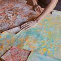 hands moving large colorful pieces of paper