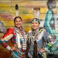 two Indigenous women in full regalia