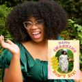 author with image of book cover in front