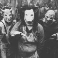 black and white photo of people in scary masks