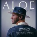 person in a hat and jean jacket with name of album printed on the back