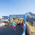 people starting a race under a banner with Mount Hood in the background