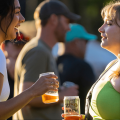 people enjoying a beer in glasses with Zoo Brew logo