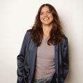 woman in a blue jacket smiling