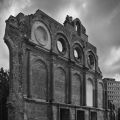 the remnants of a brick front building photographed in black and white
