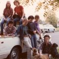 a group of women pose on and around a small white pickup truck