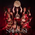 a group of women in red costumes with jewel adornments