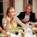 people sitting at a dinner table having a discussion