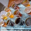 various beers in different shades poured into tasting cups