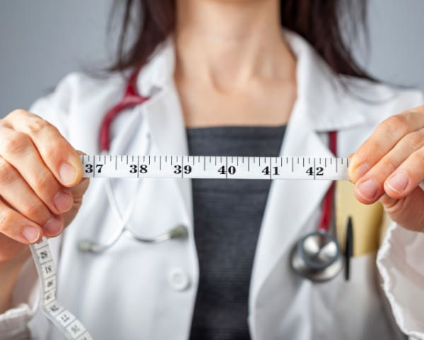 Healthcare professional with measuring tape