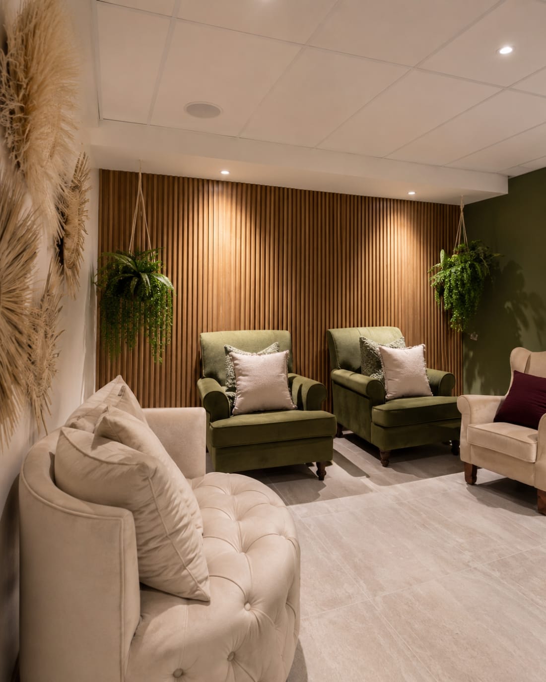 The olive velvet waiting lounge at The Vault Spa with warm timber details