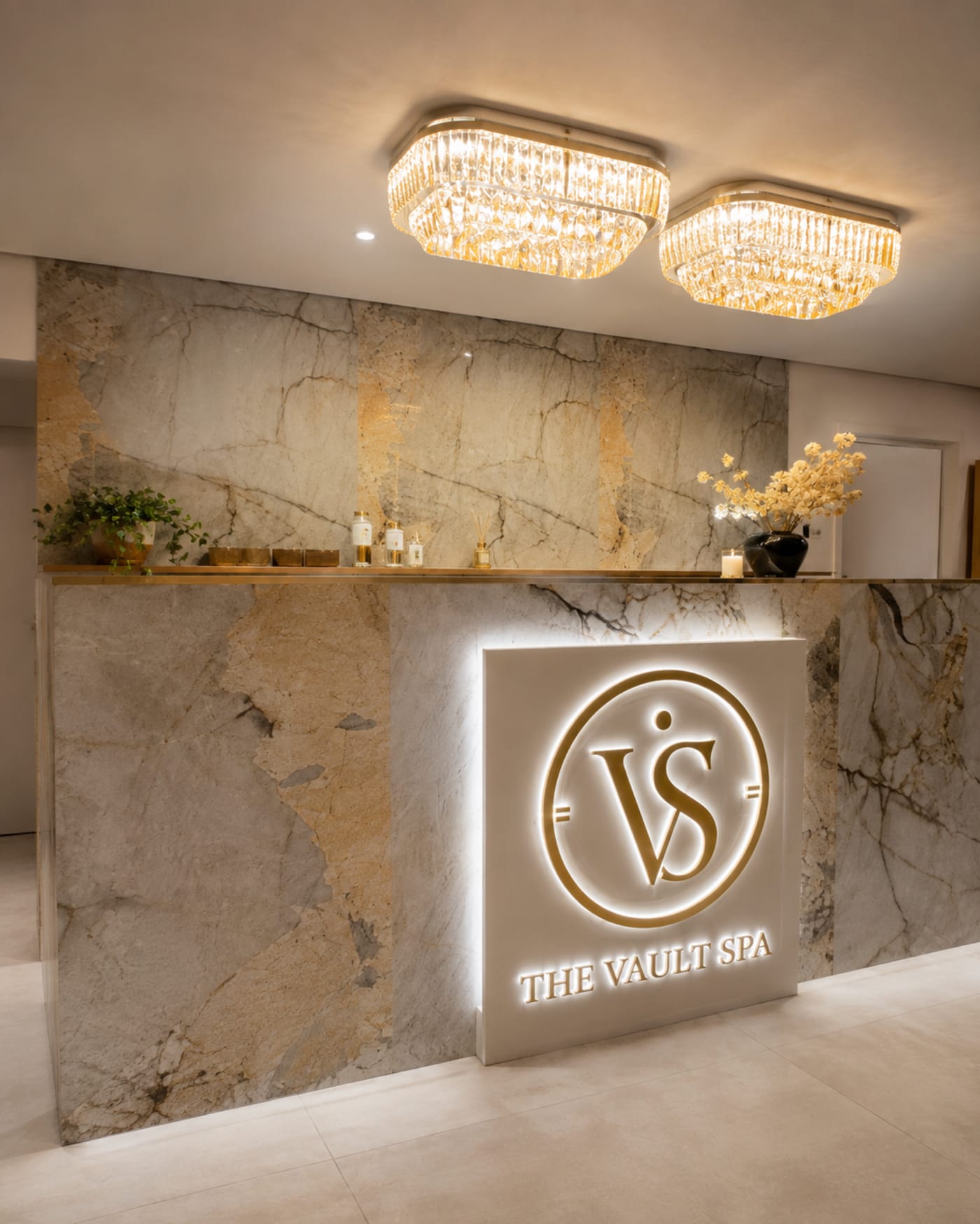 The Vault Spa marble reception with the brand logo