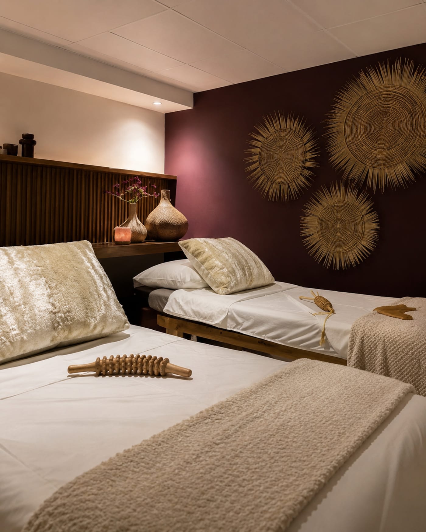 Twin massage room with rich oxblood walls at The Vault Spa