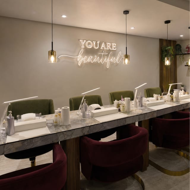 Nail bar with “You are beautiful” signage