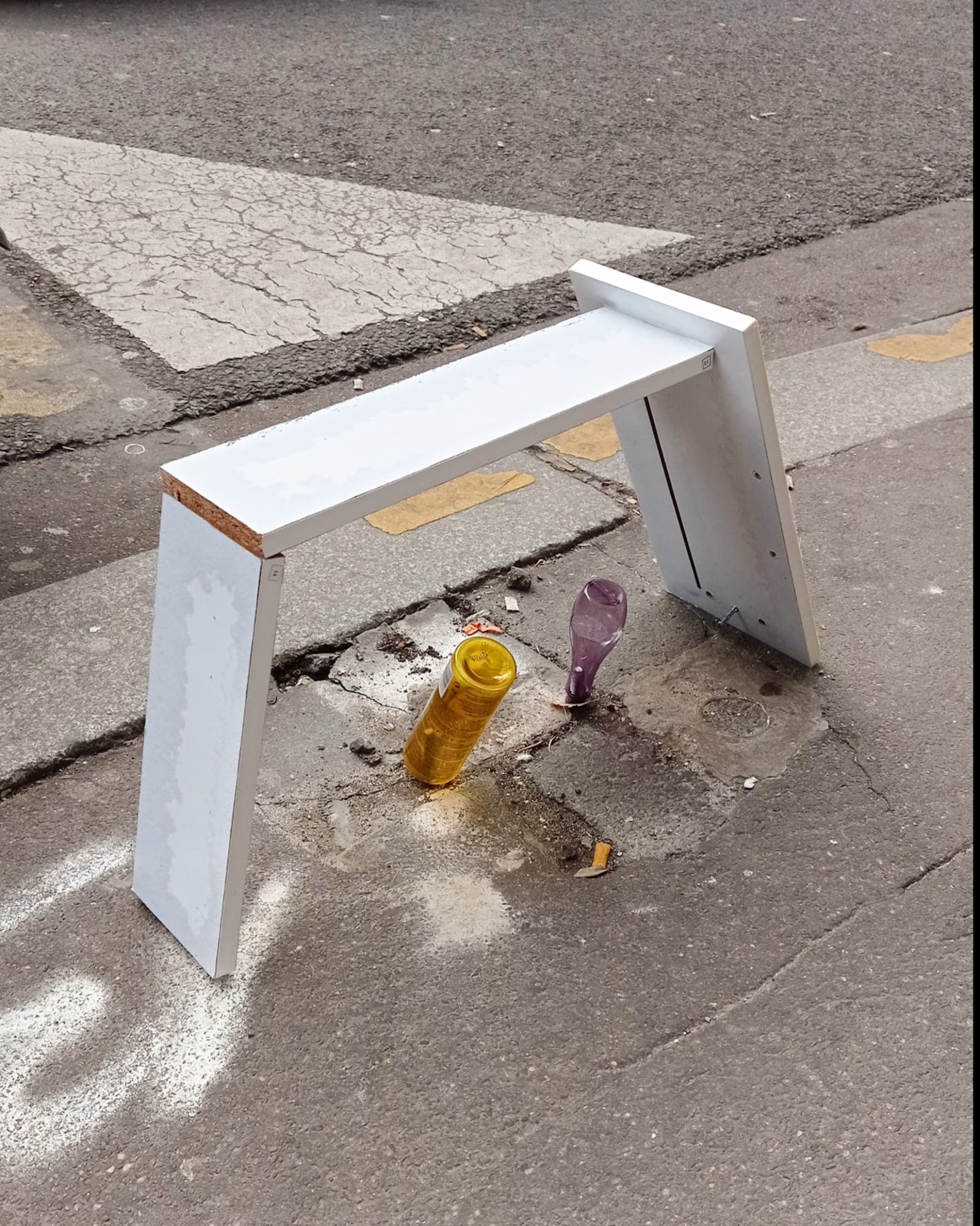 housing - a very small construction houses very small sculptures - wood, yellow plastic bottle, purple plastic bottle, white spray paint - paul lahana