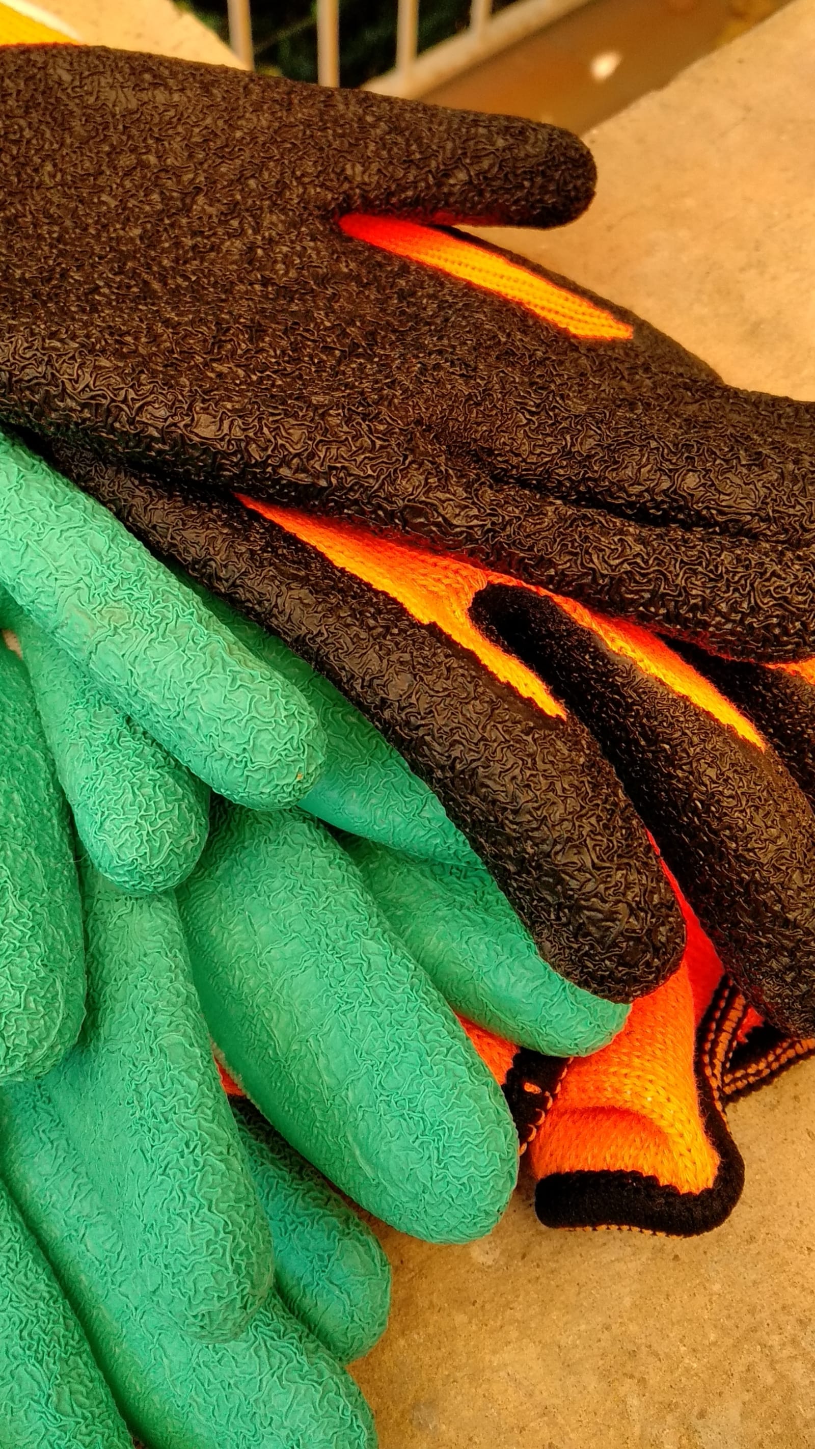 lots of fingers - two pairs of textured orange and black gloves were left with two pairs of textured green gloves - four pairs of gloves (orange, black, green) - paul lahana