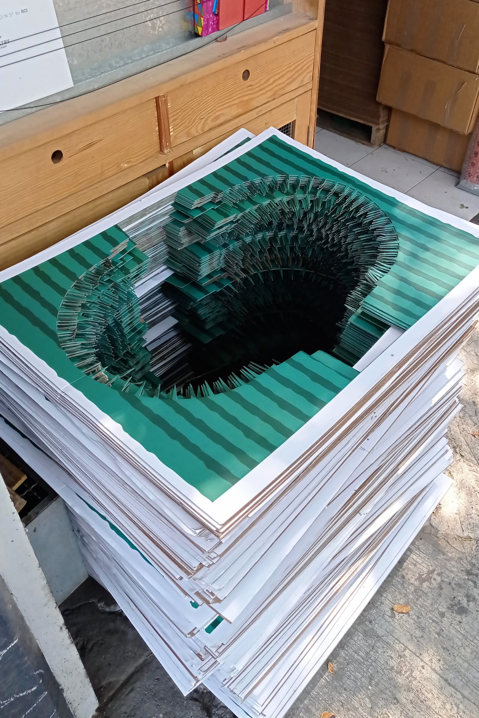 stadium - a gigantic stadium is cut through many grass prints piled up - gigantic stadium, grass prints - paul lahana