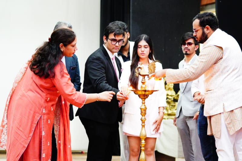 Guests and organisers light the ceremonial lamp at the Delhi MUN 1.0 inauguration