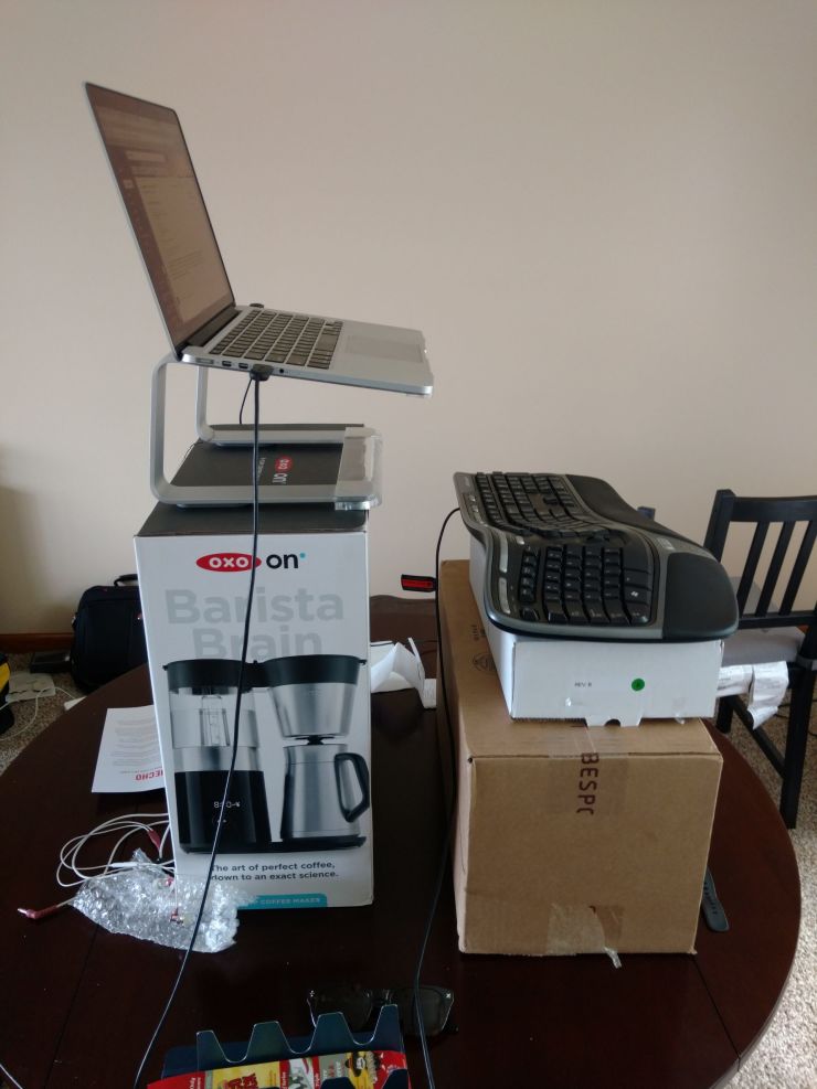 Computer equipment on boxes as a makeshift standing desk
