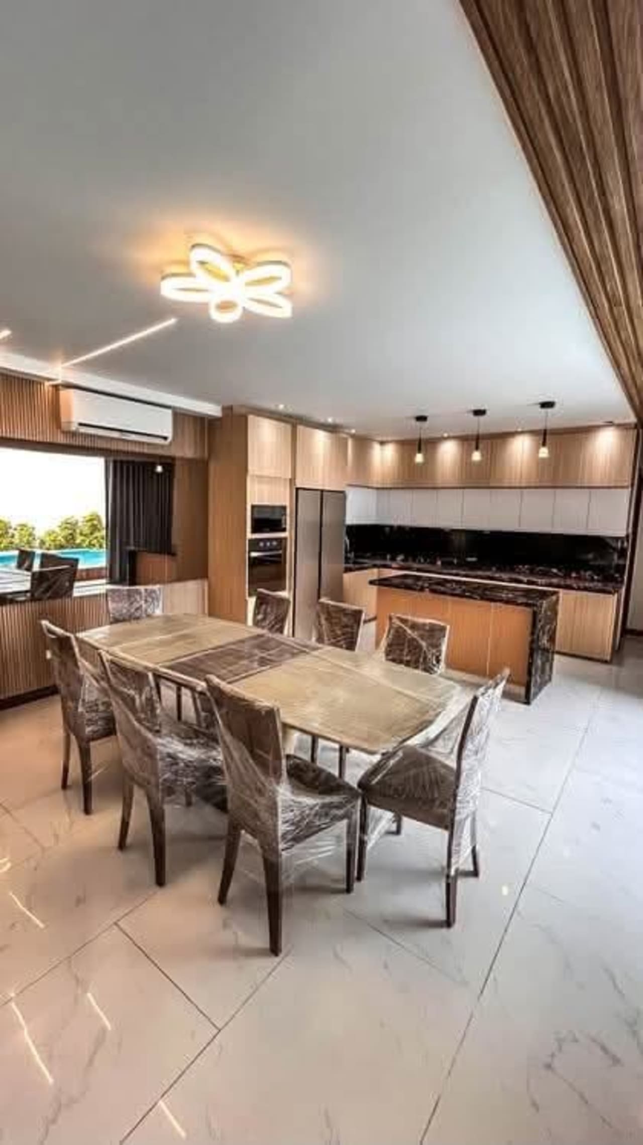 Large dining area and kitchen with eight-seat table in Vista Grande luxury home
