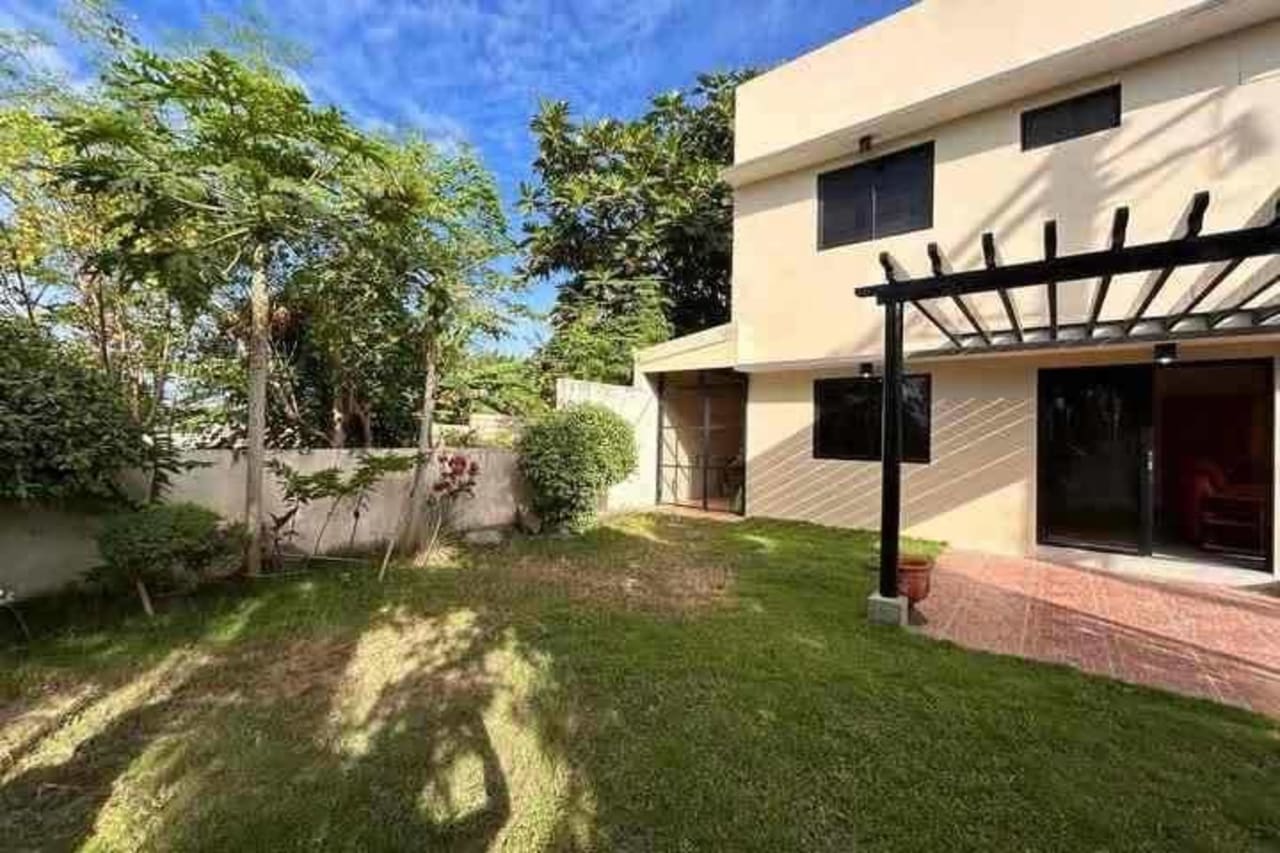 Outside view of the house with grass  and trees in House & Lot for Sale in Liloan, Cebu