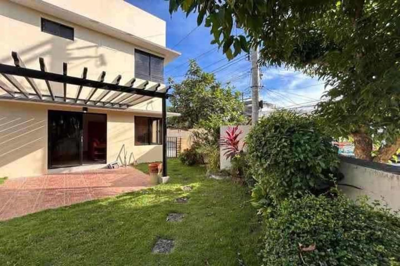 Outside view facing the house with grass in House & Lot for Sale in Liloan, Cebu