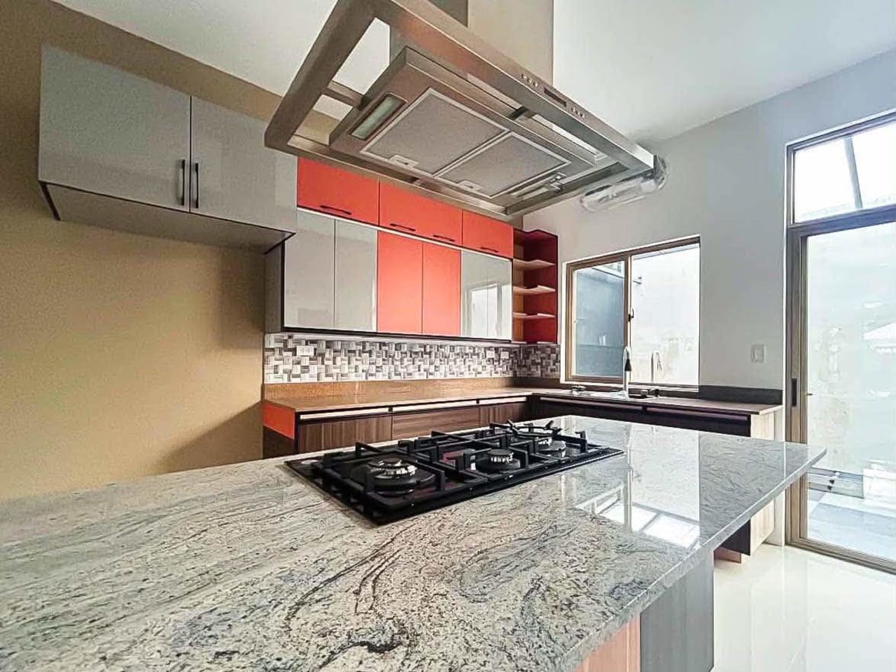 Kitchen with stove and exhaust hood in 4-bedroom townhouse for sale in Cebu City