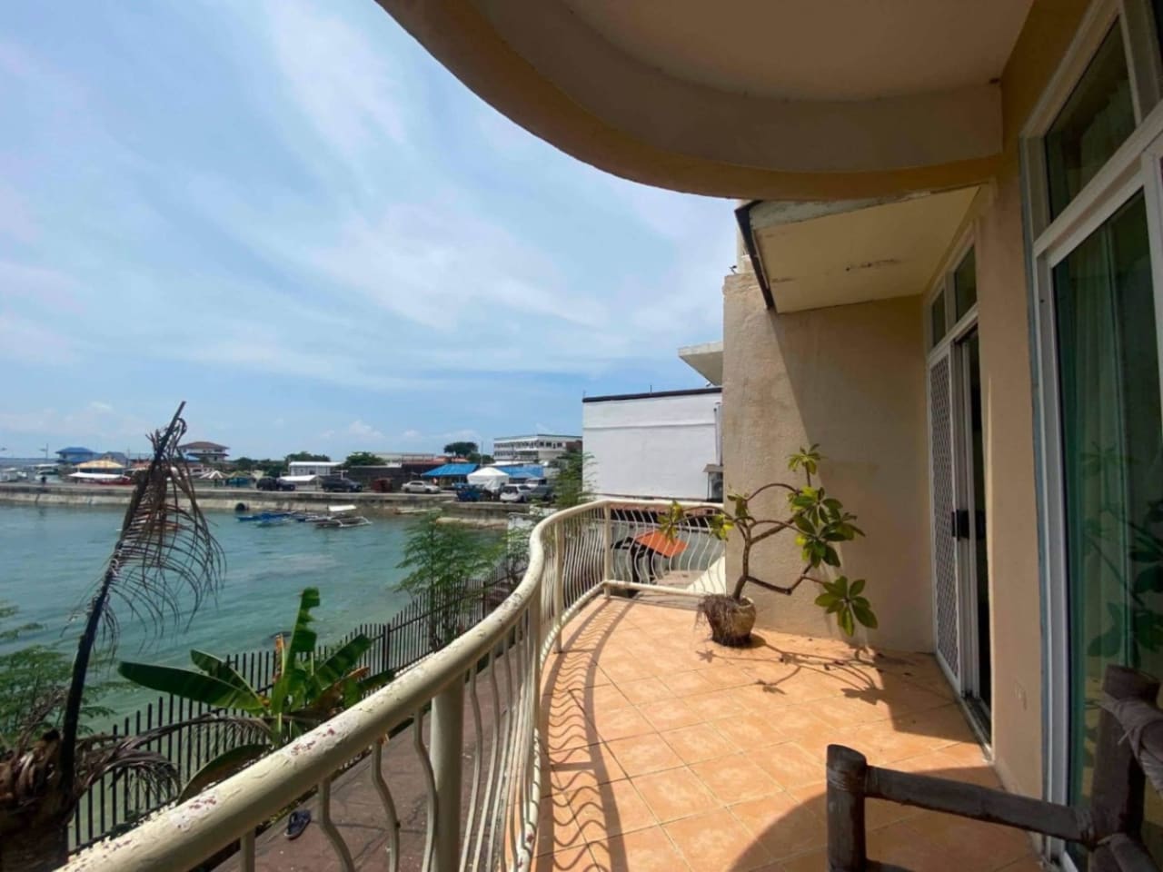 Balcony with white railing and sea view at waterfront property in Mactan Cebu