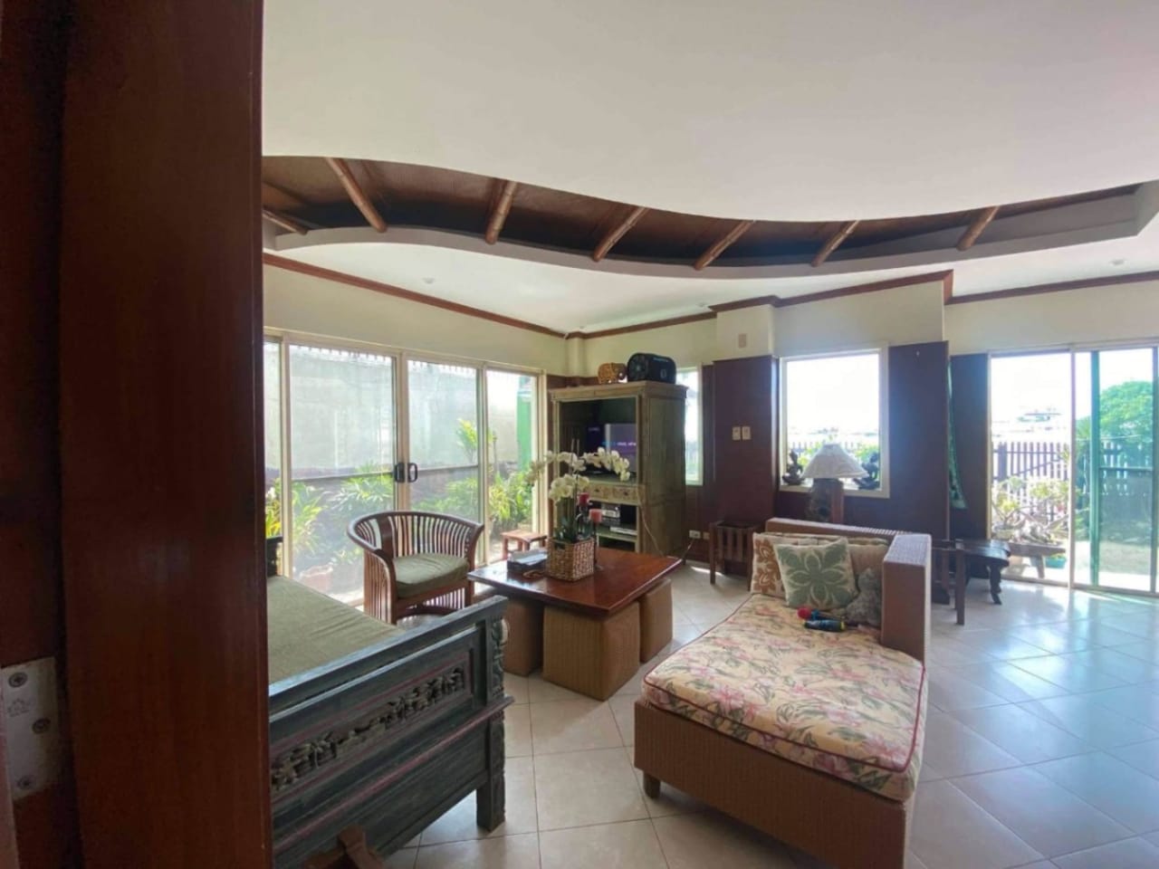 Living room with seating area inside waterfront house for sale in Mactan Cebu