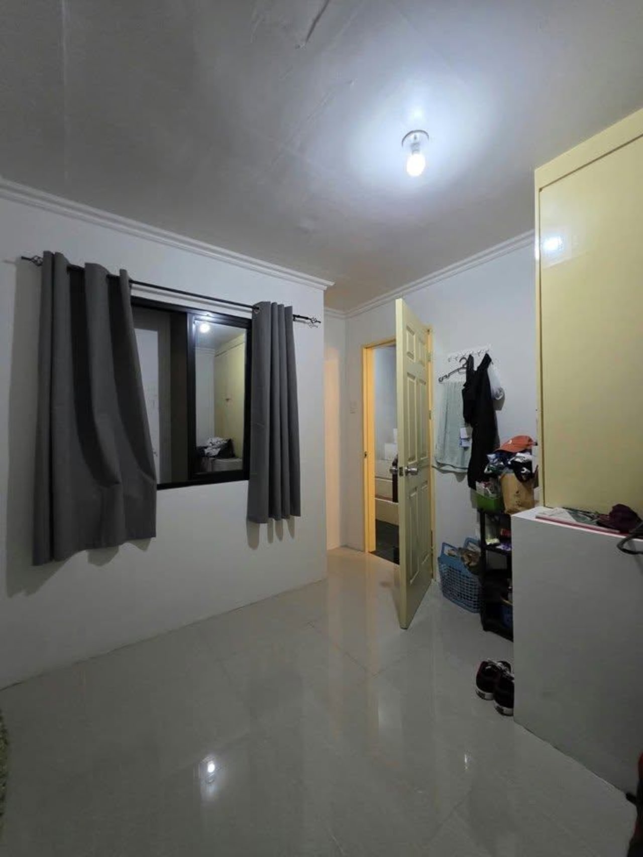 Inside a bedroom with black curtains house and lot for sale in Tisa