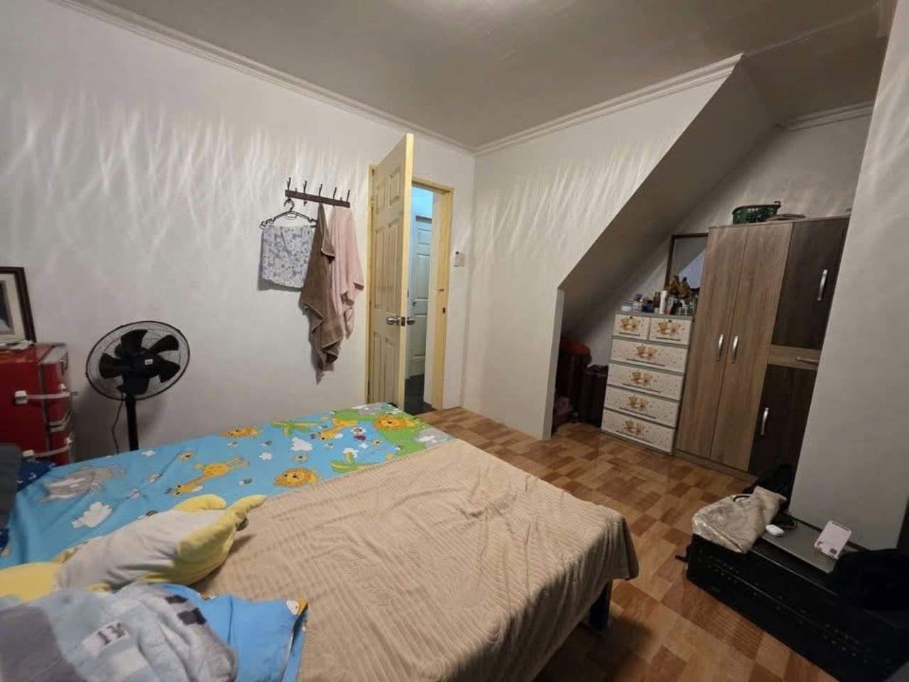 Inside a room facing the door with brown floor house and lot for sale in Tisa