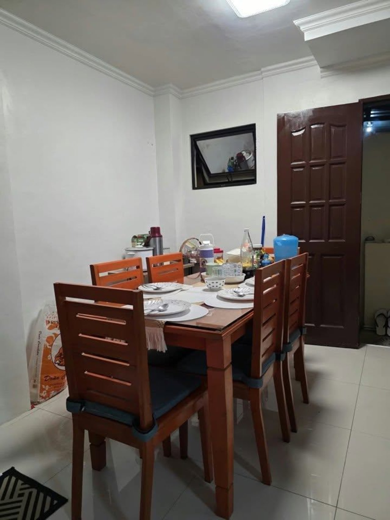 Brown dining table and chairs with white walls house and lot for sale in Tisa