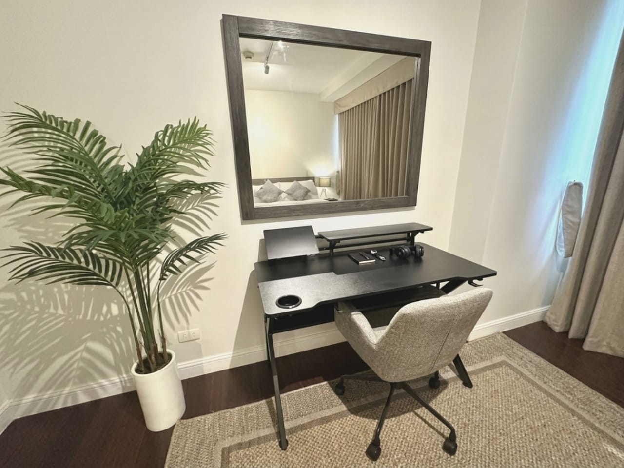 Home office desk and chair beside furnished bedroom in 1-bedroom condo for sale at The Alcoves Cebu