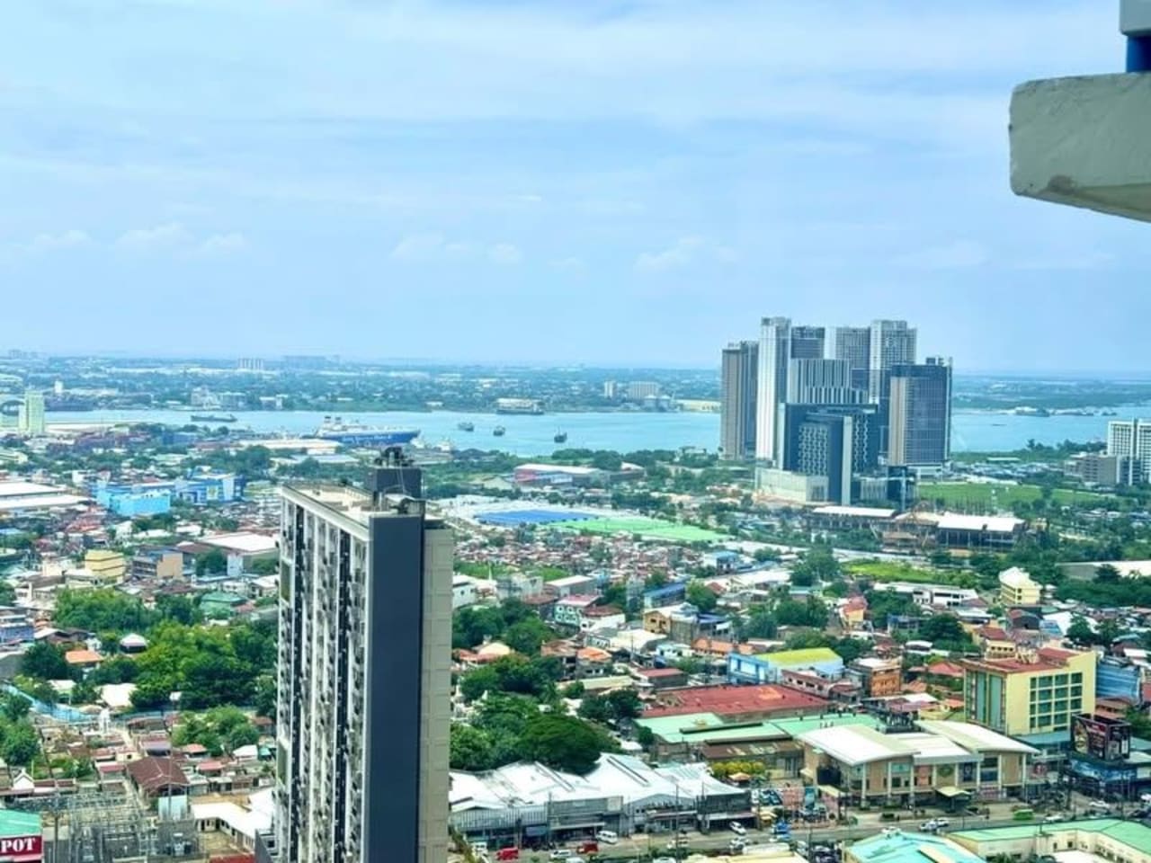High-floor sea view overlooking Mandaue City, Cebu coastline and surrounding buildings from JTower Residences