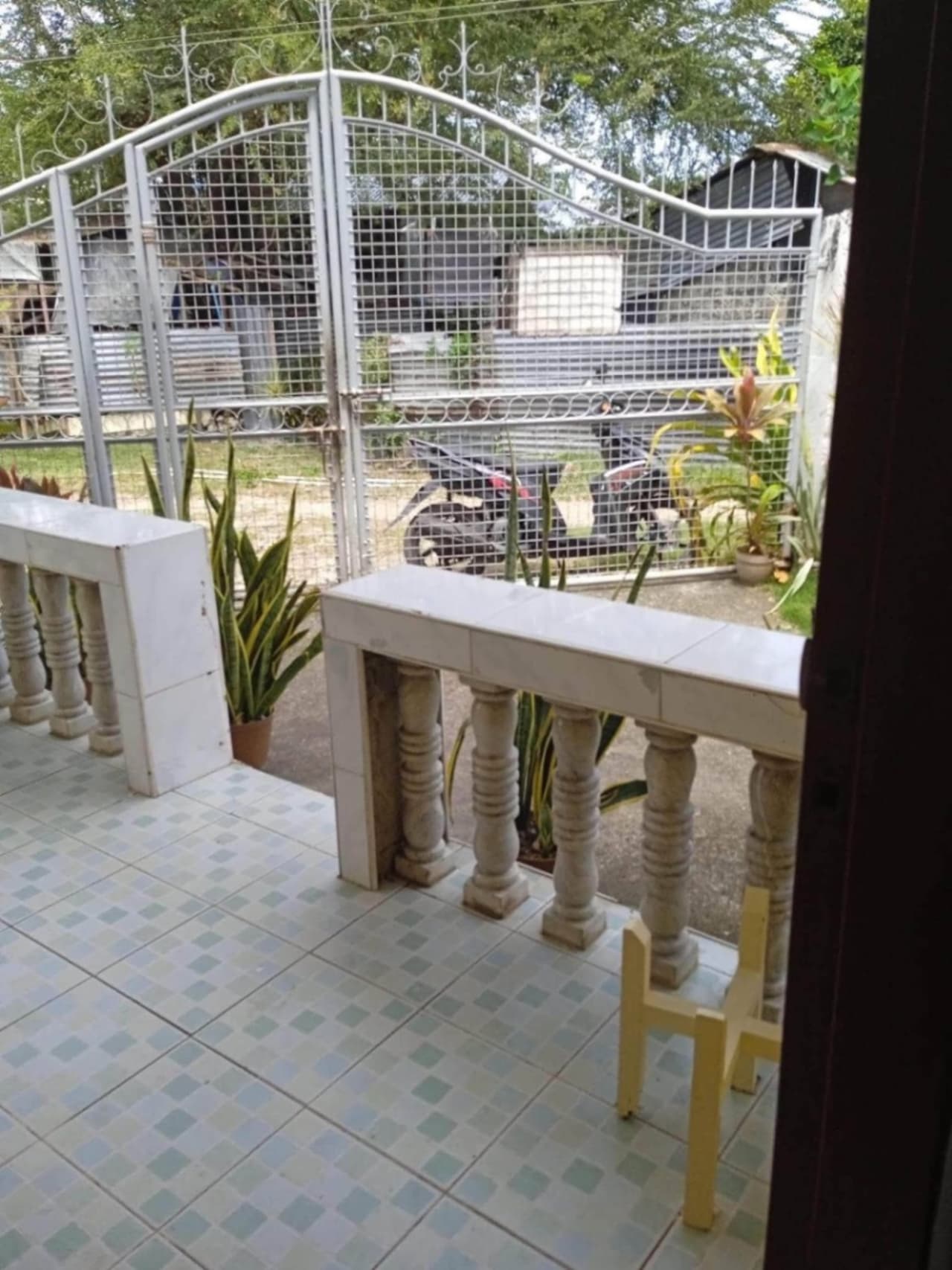 Gated entrance and concrete perimeter fence of a 326 sqm house and lot for sale in Cordova, Cebu.