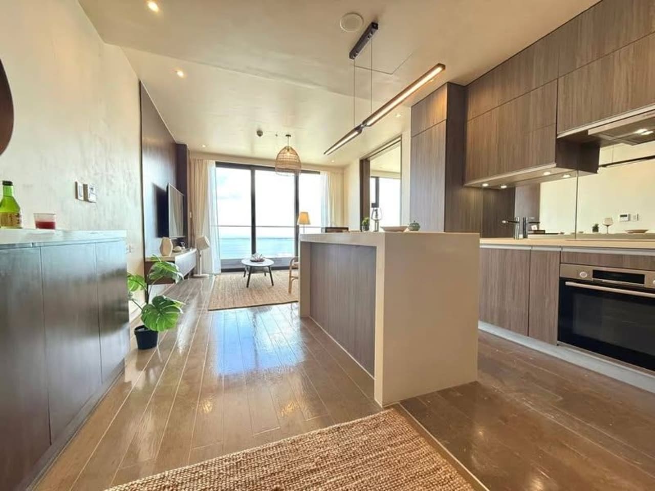 Modern kitchen with built-in appliances, refrigerator, and countertop in a fully furnished one-bedroom condo for sale in Mactan, Cebu.